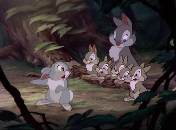 Movie still from “Bambi” (1942), directed by David Hand – A group of rabbits in the woods with a baby bunny; Wide shot, Low angle