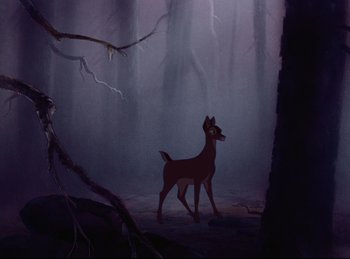 Movie still from “Bambi” (1942), directed by David Hand – A deer standing in the middle of a dark forest; Wide shot, Over the shoulder angle