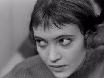 Movie still from “Band of Outsiders” (1964), directed by Jean-Luc Godard – A person's face in a black and white photo; Close Up shot, Over the shoulder angle
