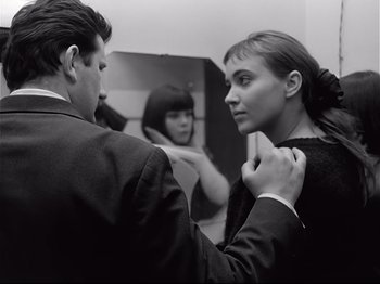 Movie still from “Band of Outsiders” (1964), directed by Jean-Luc Godard – A man and a woman in front of a bathroom mirror; Close Up shot, Over the shoulder angle