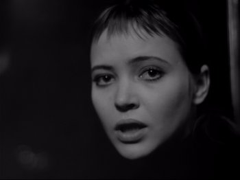 Movie still from “Band of Outsiders” (1964), directed by Jean-Luc Godard – A black - and - white photo of a woman's face; Close Up shot, Over the shoulder angle