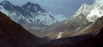 Movie still from “Baraka” (1992), directed by Ron Fricke – A view of a mountain range with snow on the top; Extreme Wide shot, Low angle