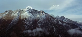 Movie still from “Baraka” (1992), directed by Ron Fricke – A view of a mountain range with snow on it; Extreme Wide shot, Low angle