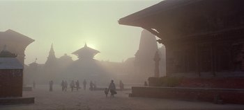 Movie still from “Baraka” (1992), directed by Ron Fricke – People walking on a street in the fog; Extreme Wide shot, Low angle