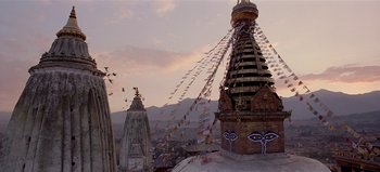 Movie still from “Baraka” (1992), directed by Ron Fricke – A view of a city from the top of a building; Extreme Wide shot, Low angle