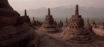 Movie still from “Baraka” (1992), directed by Ron Fricke – A view of a group of stone structures in the middle of the day; Extreme Wide shot, Low angle