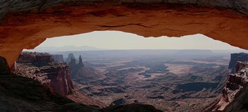 Movie still from “Baraka” (1992), directed by Ron Fricke – A view of a valley from a cave in the desert; Extreme Wide shot, High angle