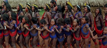 Movie still from “Baraka” (1992), directed by Ron Fricke – A group of people are standing in a line; Wide shot, High angle