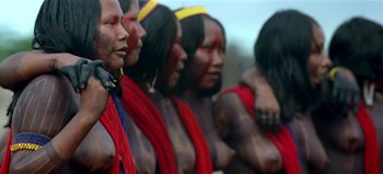 Movie still from “Baraka” (1992), directed by Ron Fricke – A group of people standing next to each other; Medium shot, Low angle