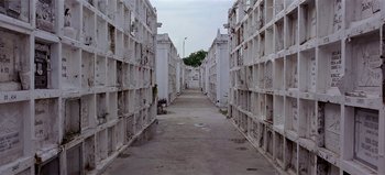 Movie still from “Baraka” (1992), directed by Ron Fricke – An alley way between two buildings in an industrial area; Extreme Wide shot, High angle