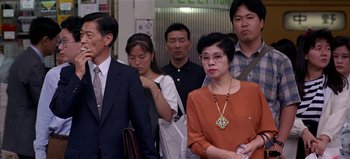 Movie still from “Baraka” (1992), directed by Ron Fricke – A group of people standing in a room; Medium shot, High angle