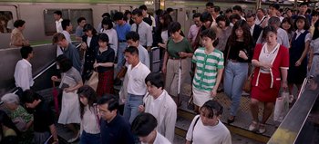Movie still from “Baraka” (1992), directed by Ron Fricke – A group of people that are standing in a room; Wide shot, High angle