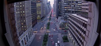Movie still from “Baraka” (1992), directed by Ron Fricke – An aerial view of a busy city street at dusk; Extreme Wide shot, High angle