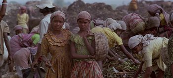 Movie still from “Baraka” (1992), directed by Ron Fricke – A group of women standing next to each other on top of a hill; Medium shot, Low angle