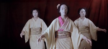Movie still from “Baraka” (1992), directed by Ron Fricke – A group of young women dressed in traditional geishas; Medium shot, Low angle