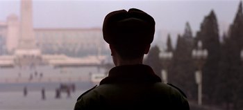 Movie still from “Baraka” (1992), directed by Ron Fricke – A man wearing a hat looking out of a window; Close Up shot, Over the shoulder angle