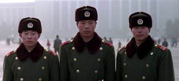 Movie still from “Baraka” (1992), directed by Ron Fricke – A group of men in military uniforms standing next to each other; Medium shot, Low angle