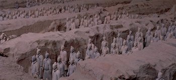 Movie still from “Baraka” (1992), directed by Ron Fricke – A large group of statues in the middle of a field; Extreme Wide shot, High angle