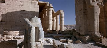 Movie still from “Baraka” (1992), directed by Ron Fricke – A view of a large stone structure in the middle of the desert; Extreme Wide shot, Low angle