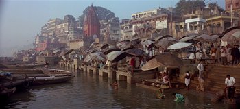 Movie still from “Baraka” (1992), directed by Ron Fricke – A group of people standing next to a body of water; Extreme Wide shot, High angle
