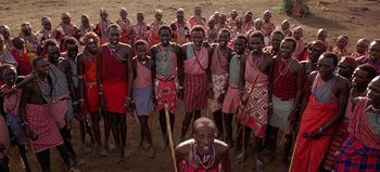 Movie still from “Baraka” (1992), directed by Ron Fricke – A group of people standing in a field; Wide shot, High angle