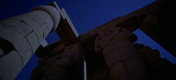 Movie still from “Baraka” (1992), directed by Ron Fricke – A view of a night sky from the ground of an ancient egyptian temple; Extreme Wide shot, Low angle