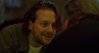 Movie still from “Barfly” (1987), directed by Barbet Schroeder – A person with long hair; Close Up shot, Over the shoulder angle