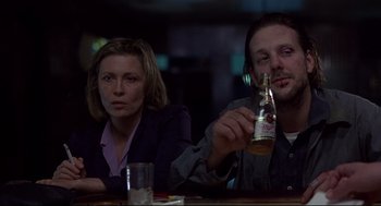 Movie still from “Barfly” (1987), directed by Barbet Schroeder – A man and a woman sitting at a table; Medium shot, Low angle