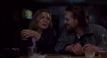 Movie still from “Barfly” (1987), directed by Barbet Schroeder – A woman and a man sitting at a table talking to each other; Close Up shot, Over the shoulder angle