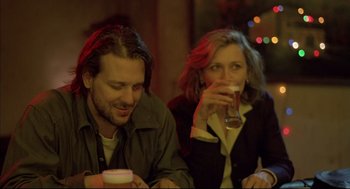 Movie still from “Barfly” (1987), directed by Barbet Schroeder – A man and a woman sitting next to each other at a table; Close Up shot, Low angle