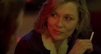 Movie still from “Barfly” (1987), directed by Barbet Schroeder – A woman's face in a dark room; Close Up shot, Over the shoulder angle