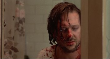 Movie still from “Barfly” (1987), directed by Barbet Schroeder – A person with blood all over his face; Close Up shot, Low angle