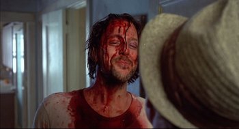Movie still from “Barfly” (1987), directed by Barbet Schroeder – A man with blood all over his face; Close Up shot, Over the shoulder angle