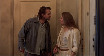Movie still from “Barfly” (1987), directed by Barbet Schroeder – A man and a woman standing next to each other; Medium shot, Low angle