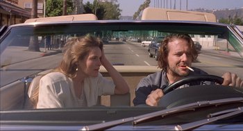 Movie still from “Barfly” (1987), directed by Barbet Schroeder – A man and a woman in the back seat of a car; Medium shot, Low angle