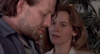 Movie still from “Barfly” (1987), directed by Barbet Schroeder – A man and a woman face to face in front of a mirror; Close Up shot, Low angle