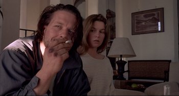 Movie still from “Barfly” (1987), directed by Barbet Schroeder – A man and a woman standing next to each other in a room; Close Up shot, Low angle