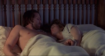 Movie still from “Barfly” (1987), directed by Barbet Schroeder – A man and a woman laying in a bed together; Medium shot, Overhead angle