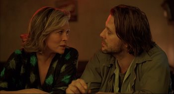 Movie still from “Barfly” (1987), directed by Barbet Schroeder – A man and a woman sitting next to each other at a table; Close Up shot, Over the shoulder angle