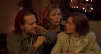 Movie still from “Barfly” (1987), directed by Barbet Schroeder – A group of people sitting at a table together; Close Up shot, Over the shoulder angle