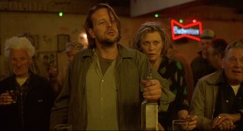 Movie still from “Barfly” (1987), directed by Barbet Schroeder – A man and a woman standing next to each other at a bar; Close Up shot, Low angle