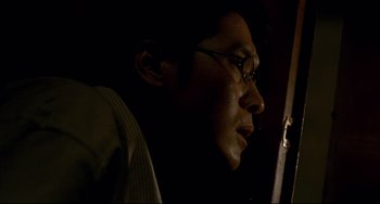 Movie still from “Barking Dogs Never Bite” (2000), directed by Bong Joon Ho – A man with glasses looking at a computer screen; Close Up shot, Low angle