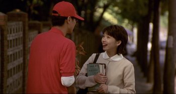 Movie still from “Barking Dogs Never Bite” (2000), directed by Bong Joon Ho – A man and a woman talking to each other outside; Medium shot, Over the shoulder angle