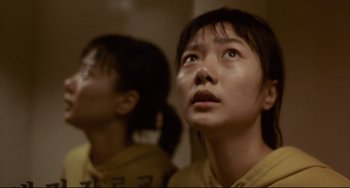 Movie still from “Barking Dogs Never Bite” (2000), directed by Bong Joon Ho – Two young women looking up in a room; Close Up shot, Low angle