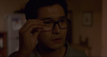 Movie still from “Barking Dogs Never Bite” (2000), directed by Bong Joon Ho – A person wearing glasses; Close Up shot, Low angle