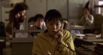 Movie still from “Barking Dogs Never Bite” (2000), directed by Bong Joon Ho – A person talking on a phone in a room; Close Up shot, High angle