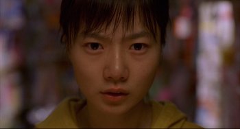 Movie still from “Barking Dogs Never Bite” (2000), directed by Bong Joon Ho – A young person's face; Close Up shot, Low angle