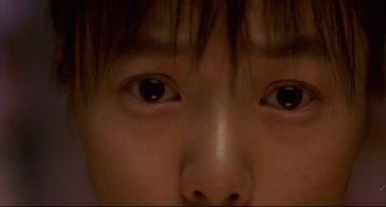 Movie still from “Barking Dogs Never Bite” (2000), directed by Bong Joon Ho – A person's eyes and hair; Extreme Close Up shot, Overhead angle
