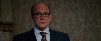 Movie still from “Step Brothers” (2008), directed by Adam McKay – A man in a suit and tie wearing glasses; Close Up shot, Low angle