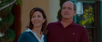 Movie still from “Step Brothers” (2008), directed by Adam McKay – An older man standing next to an older woman in front of a building; Close Up shot, Low angle